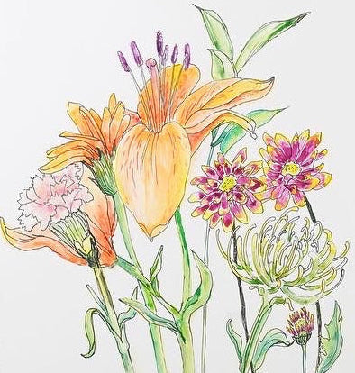 Artistic sketchbook with floral illustration on a table with art supplies